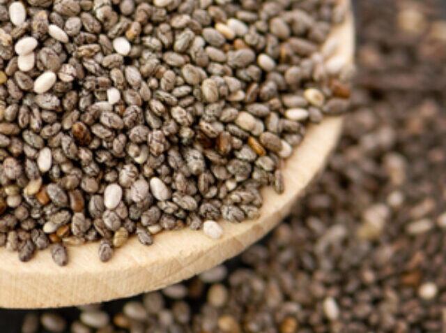 Nutritious chia seeds on a spoon, close up.